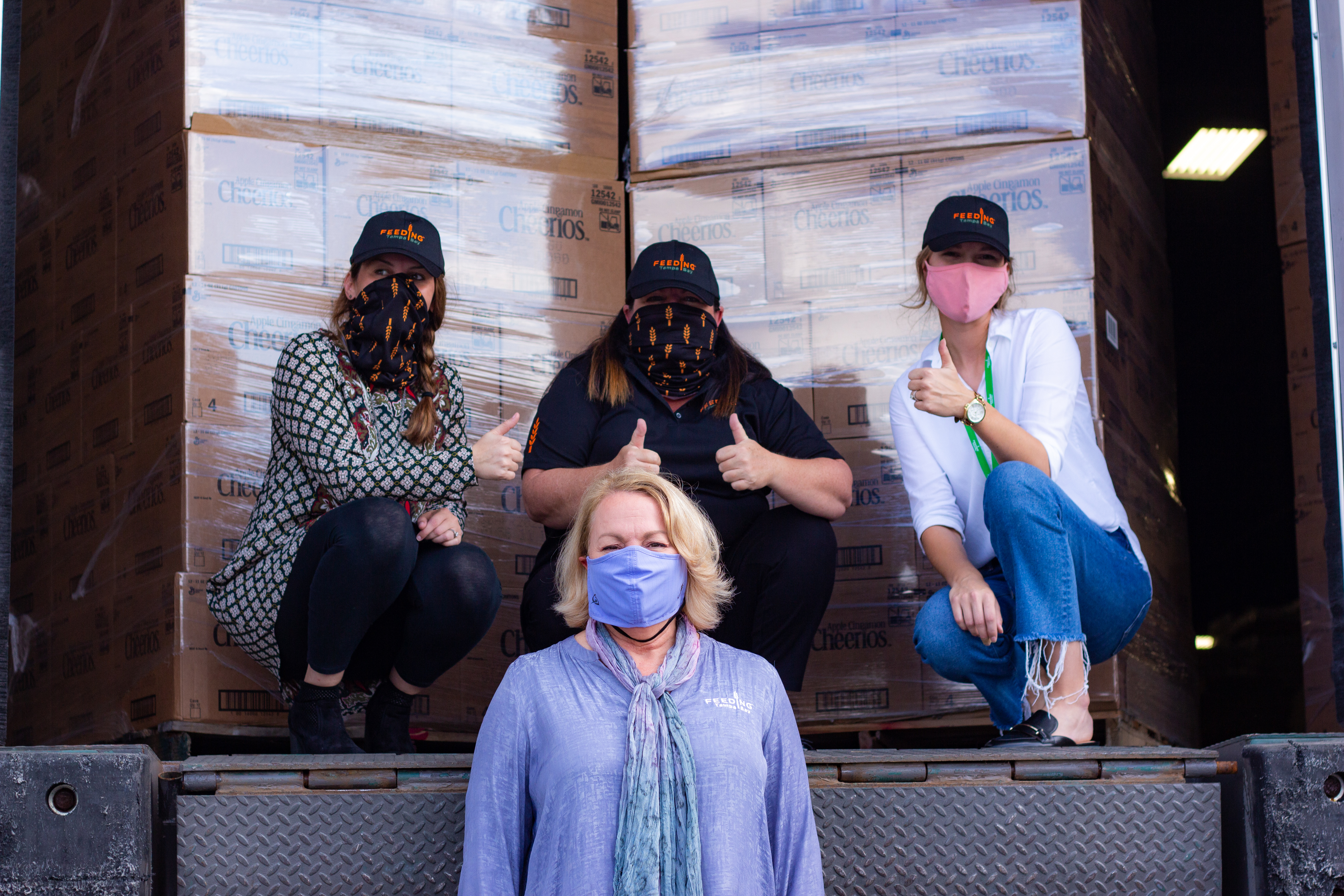 Feeding America giving thumbs up in front of cereal donation