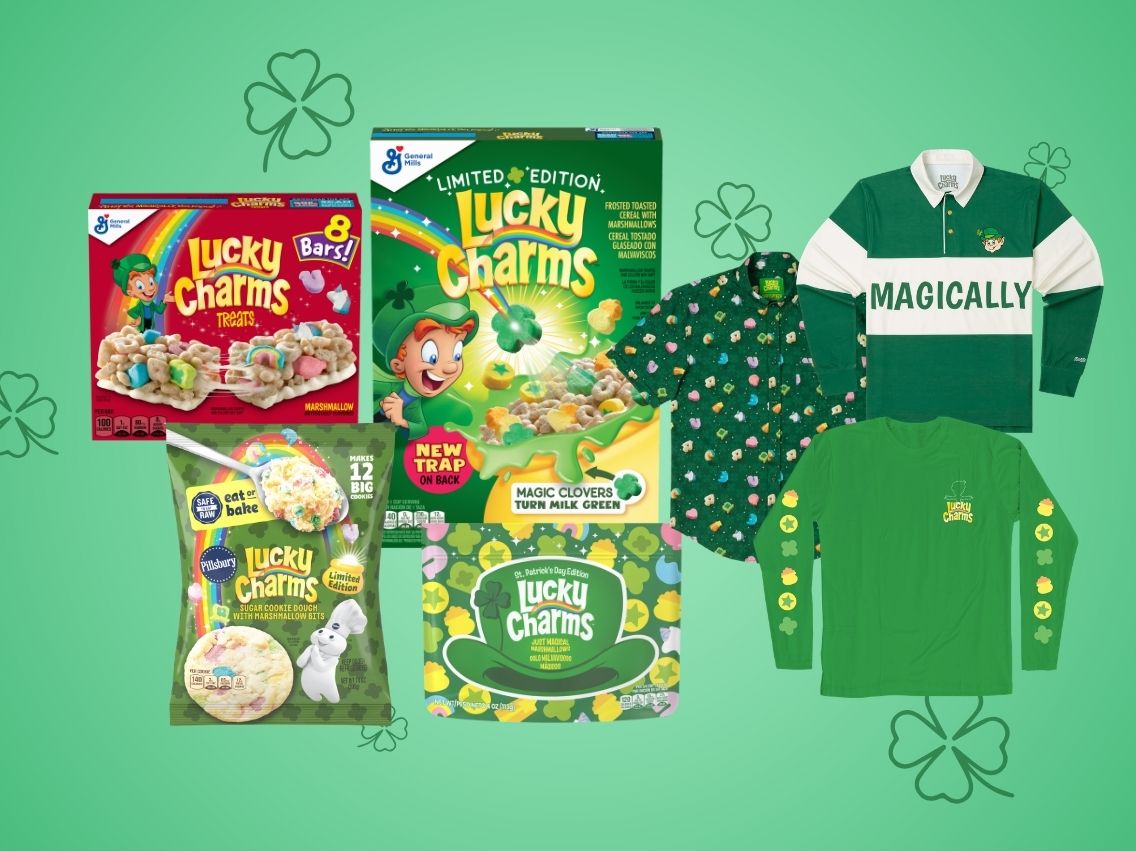 Lucky Charms products including Lucky Charms Treat Bars, Pillsbury Ready to Bake! Lucky Charms Sugar Cookie Dough and Lucky Charms Turns Milk Green Limited Edition Cereal placed on a green background with four-leaf clovers for St. Patrick’s Day.