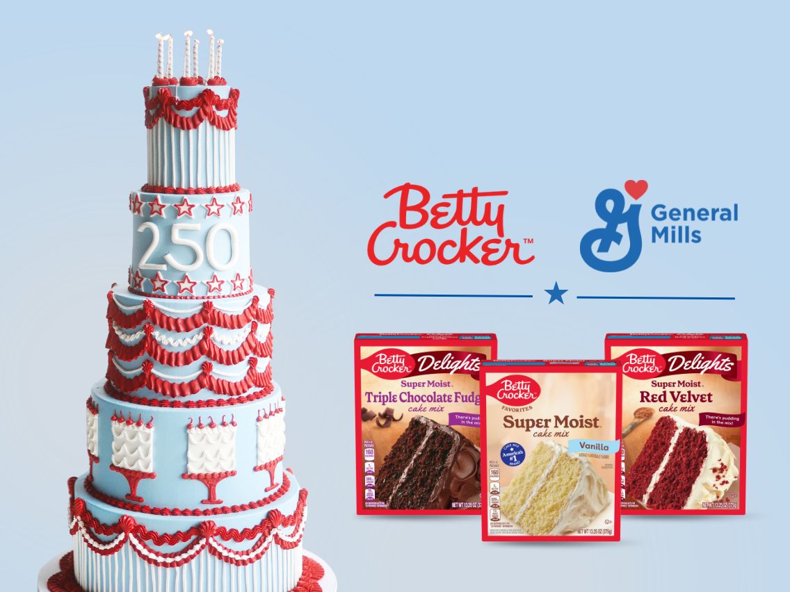 A multi-tiered red, white and blue birthday cake featuring the number “250” stands beside Betty Crocker cake mix boxes, celebrating America’s 250th birthday. The image highlights Betty Crocker’s nationwide giveaway of one million free cakes in honor of the milestone anniversary.